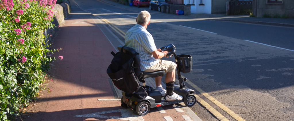 Man on mobility scooter on road