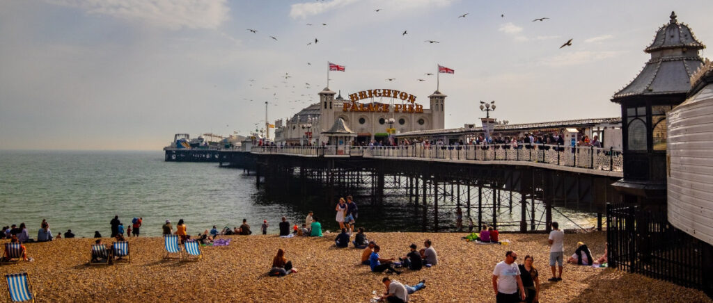 People on Brighton beach near the pier