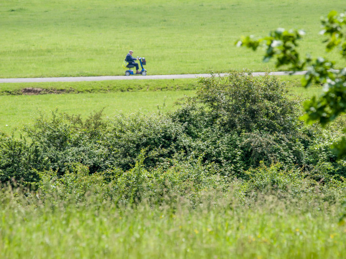 Man on mobility scooter on path in the countryside
