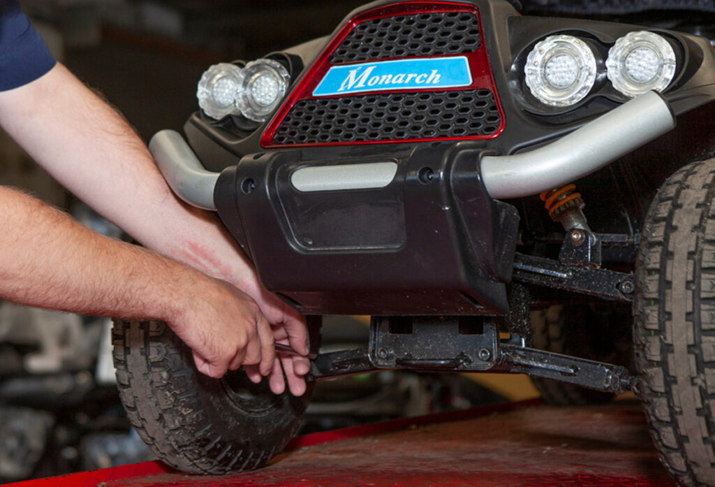A man servicing a Monarch mobility scooter