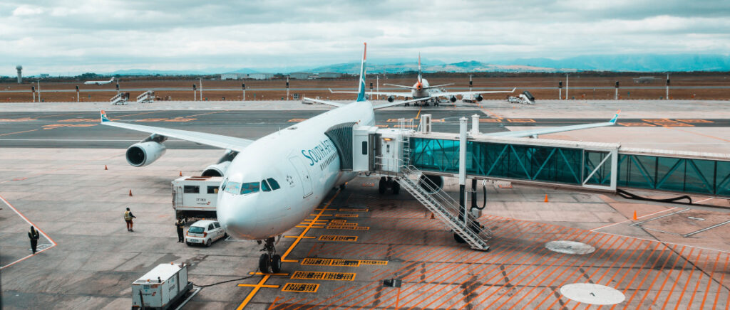 A plane with a tunnel attached for boarding