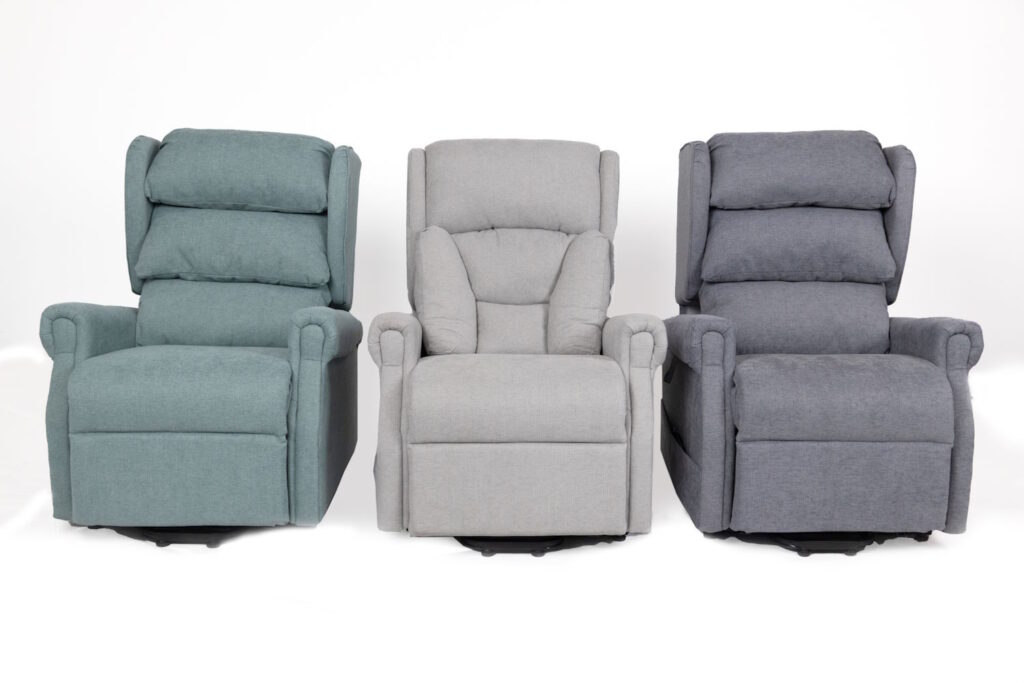 Three rise and recline chairs in blue, light grey and dark grey