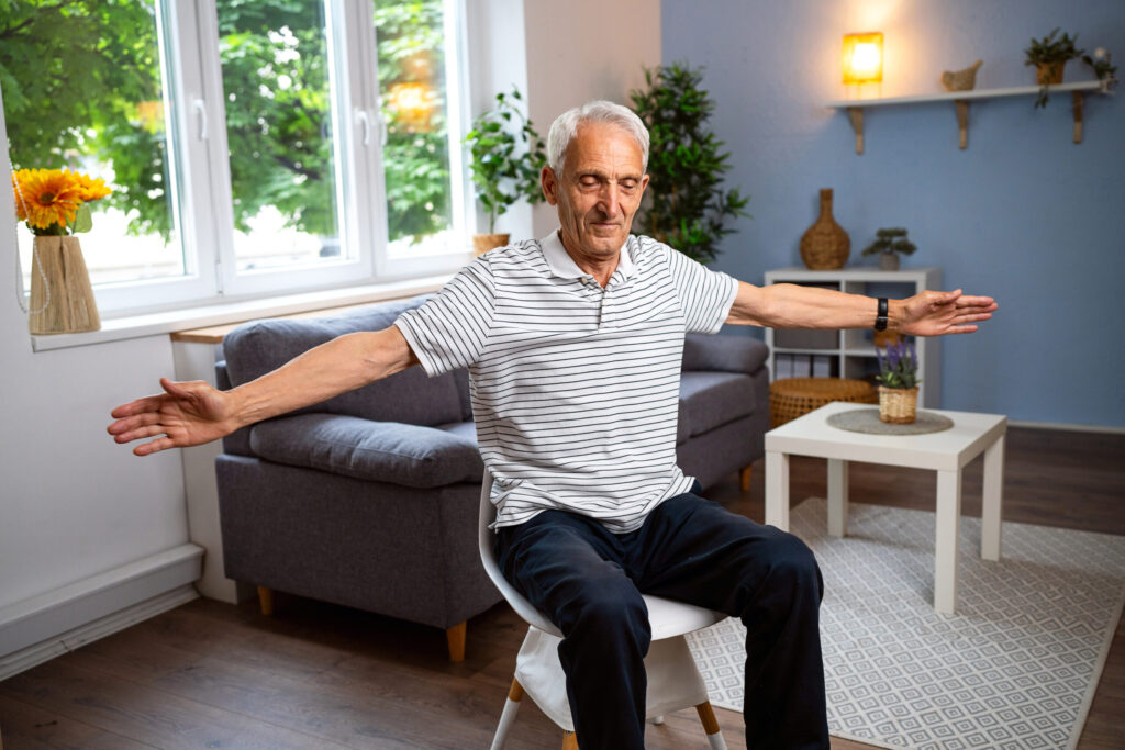 Elderly man doing chair exercises
