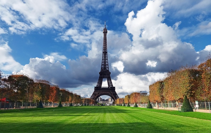 The Eiffel Tower with a lush green lawn in front of it